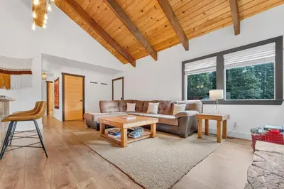 a living room with a couch and a table at Stylish 3BR Near Trails w Hot Tub in Tahoe City