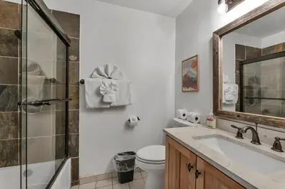 a bathroom with a toilet and a sink and a shower at Stylish 3BR Near Trails w Hot Tub in Tahoe City