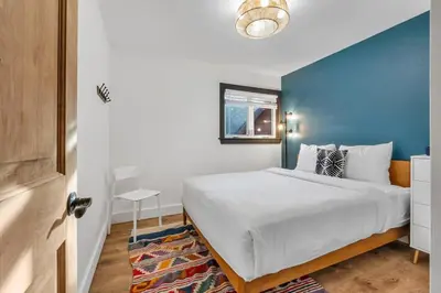 a bedroom with a large bed with a blue wall at Stylish 3BR Near Trails w Hot Tub in Tahoe City