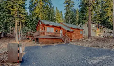 a log cabin in the woods with a driveway at Stylish 3BR Near Trails w Hot Tub in Tahoe City