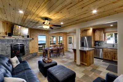 a kitchen and living room with a couch and a fireplace at Tall Pine Chalet in Stateline