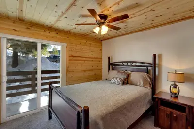 a bedroom with a bed and a ceiling fan at Tall Pine Chalet in Stateline