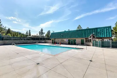 a swimming pool in a yard with a building at Snowflake Chalet in Stateline