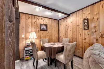 a dining room with a table and chairs at Snowflake Chalet in Stateline