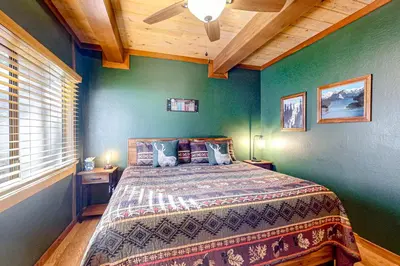 a bedroom with a bed with green walls and a ceiling at Kelly's Kastle in Incline Village