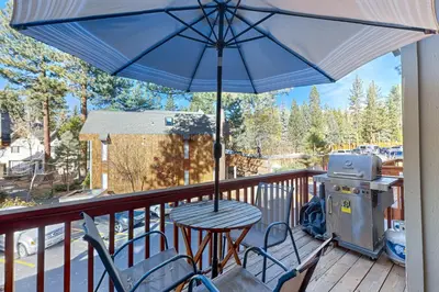 a table and chairs on a balcony with an umbrella at Kelly's Kastle in Incline Village