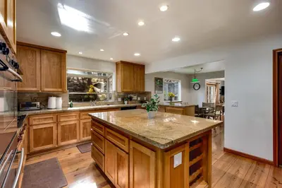 a large kitchen with wooden cabinets and a large island at Silver Rock Lodge in Zephyr Cove
