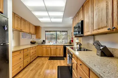 a kitchen with wooden cabinets and wooden floors at Spacious Riverfront in South Lake Tahoe