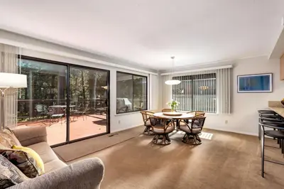 an empty living room with a table and chairs at Spacious Riverfront in South Lake Tahoe