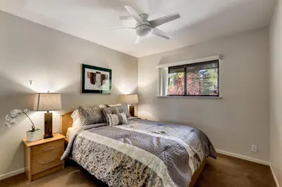 a bedroom with a bed and a ceiling fan at Spacious Riverfront in South Lake Tahoe