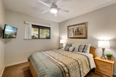 a bedroom with a bed and a ceiling fan at Spacious Riverfront in South Lake Tahoe