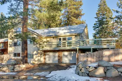 a large house with a fence in front of it at Sequoia Chalet in Stateline