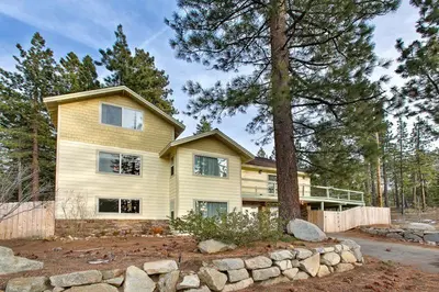 a large house with a tree in front of it at Sequoia Chalet in Stateline