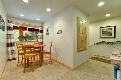 a kitchen and dining room with a table and chairs at Lodgepole Pine Chalet in South Lake Tahoe