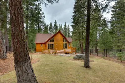 a wooden cabin in the woods with trees at Lodgepole Pine Chalet in South Lake Tahoe