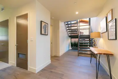 a hallway of a home with a staircase and a table at Crystal Bay Penthouse 301 in Crystal Bay