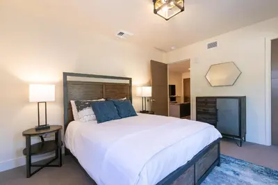 a bedroom with a large white bed with blue pillows at Crystal Bay Penthouse 301 in Crystal Bay