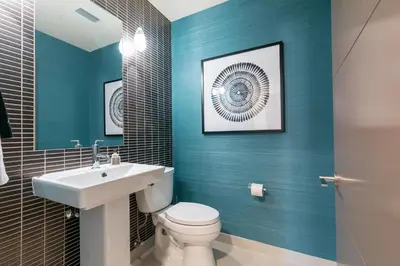 a bathroom with blue walls and a toilet and a sink at Crystal Bay Penthouse 301 in Crystal Bay