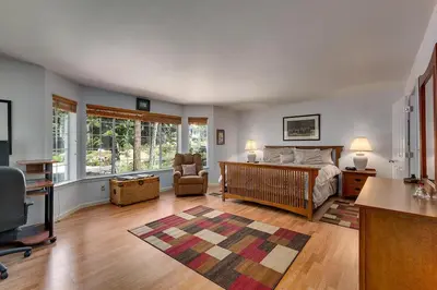 a bedroom with a bed and a desk and a chair at Panhandle House in South Lake Tahoe