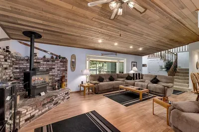 a living room with a couch and a fireplace at Panhandle House in South Lake Tahoe