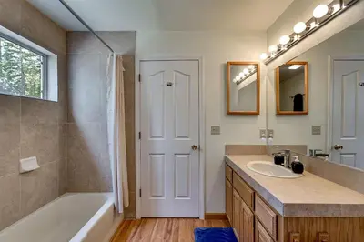 a bathroom with a tub and a sink and a shower at Panhandle House in South Lake Tahoe