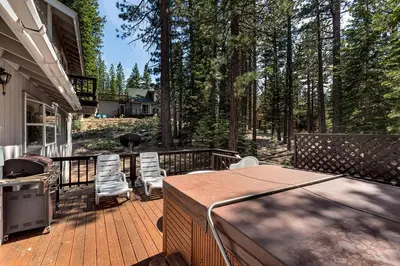 a deck with chairs and a grill on a house at Panhandle House in South Lake Tahoe