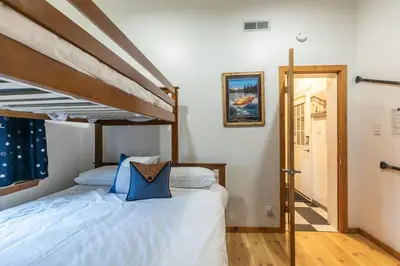 a bedroom with a bed with a wooden bed frame at Stylish 2BD in Carnelian Bay in Carnelian Bay