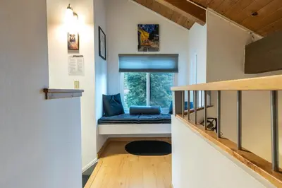 a small room with a window with a blue seat at Stylish 2BD in Carnelian Bay in Carnelian Bay