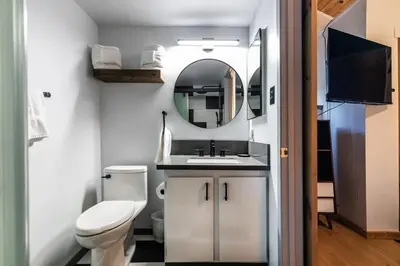 a small bathroom with a toilet and a mirror at Stylish 2BD in Carnelian Bay in Carnelian Bay