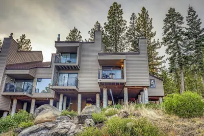 a large house on a hill with trees at Stylish 2BD in Carnelian Bay in Carnelian Bay