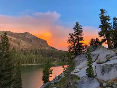 a sunset over a lake with trees and a mountain at VIP Lakefront Condo Amazing Views Pool Pickleball Excellent Location Balcony BBQ in Kings Beach