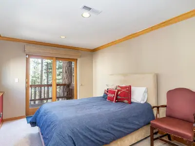 a bedroom with a bed and a chair and a window at Tahoe Pines, enjoy the outdoors this home has to offers in Incline Village