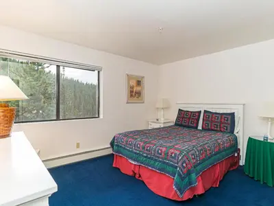 a bedroom with a bed and a large window at 4 bedroom 3 5 bathrooms lake view condo in Incline Village