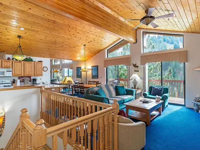 a large living room with a wooden ceiling at 4 bedroom 3 5 bathrooms lake view condo in Incline Village