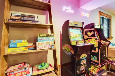 a room with a video game console and a arcade at Luna Cabin - 5BR Hot Tub A/C Game Room EV Charger in Tahoe Vista