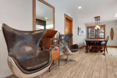 two leather chairs in a living room with a mirror at Luna Cabin - 5BR Hot Tub A/C Game Room EV Charger in Tahoe Vista
