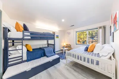 two bunk beds in a room with a window at Starry Night Cabin at Sky Ranch in Oakhurst