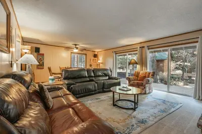 a living room with a leather couch and a table at Serene 5BDR Near Beach and Forest Trails in Carnelian Bay