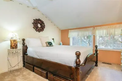 a bedroom with a large bed and a window at Serene 5BDR Near Beach and Forest Trails in Carnelian Bay