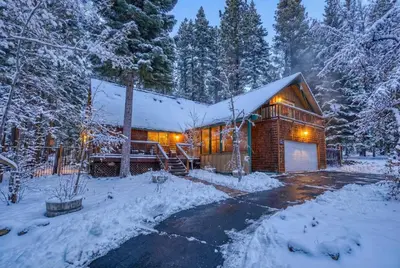 a log cabin in the snow with a garage at Serene 5BDR Near Beach and Forest Trails in Carnelian Bay