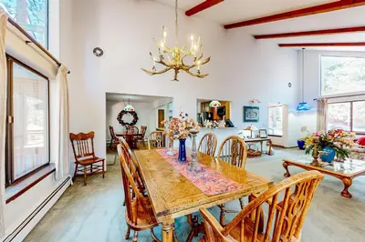 a dining room with a wooden table and chairs at Antler & Pine in South Lake Tahoe