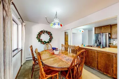 a kitchen with a wooden table and chairs at Antler & Pine in South Lake Tahoe