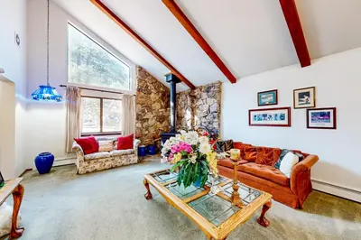 a living room with a couch and a table at Antler & Pine in South Lake Tahoe