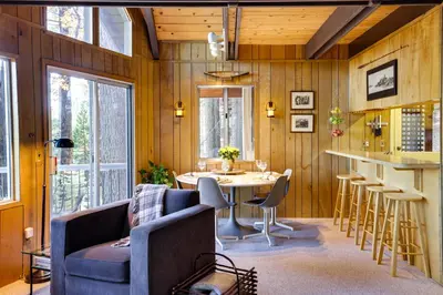 a living room with a table and chairs and a couch at 3 Mi to Big Trees State Park Cabin with Deck in Arnold