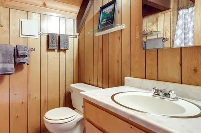 a bathroom with a sink and a toilet at 3 Mi to Big Trees State Park Cabin with Deck in Arnold