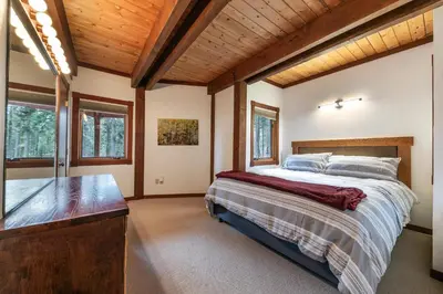 a bedroom with a bed and a wooden ceiling at Sherwood Chalet - Quiet 3 BR in Ward Canyon, Private Hot Tub, Near Sherwood Chairlift in Tahoe City