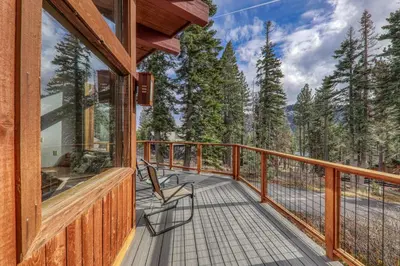 a balcony with a chair and a view of the mountains at Sherwood Chalet - Quiet 3 BR in Ward Canyon, Private Hot Tub, Near Sherwood Chairlift in Tahoe City