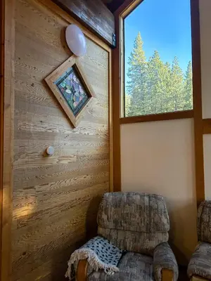 a living room with a chair and a window at Lofty Retreat, Condo in Northstar in Truckee