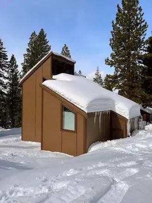 a building with snow on top of it in the snow at Lofty Retreat, Condo in Northstar in Truckee