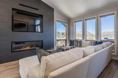a living room with a large couch and a fireplace at Snowcreek V 972 in Mammoth Lakes